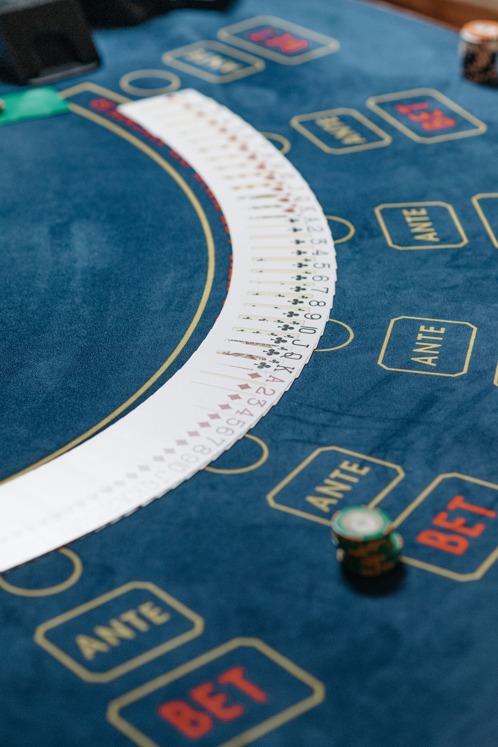 Playing cards arranged across a blue casino table