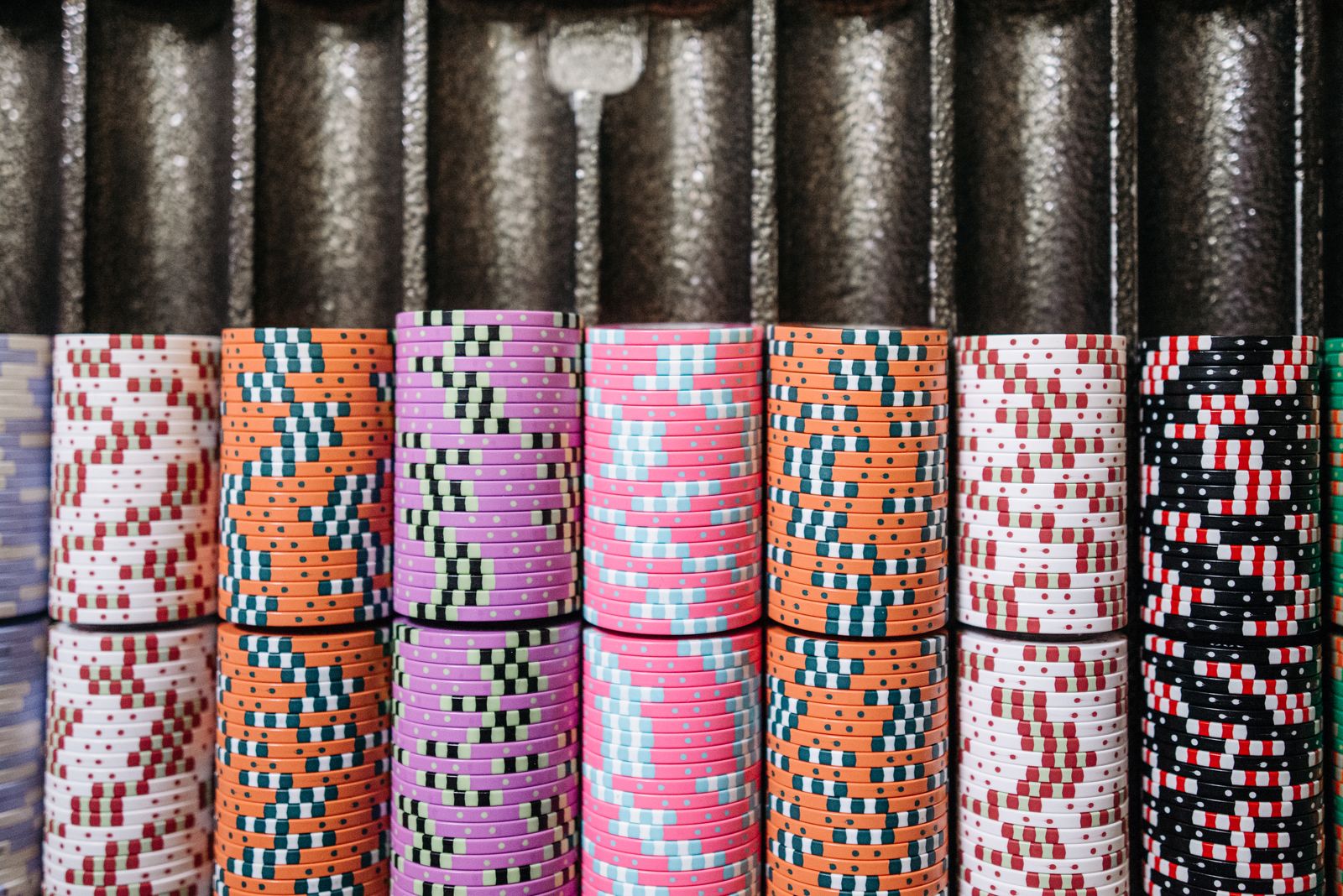 Color-coded casino chips arranged in a dealer tray